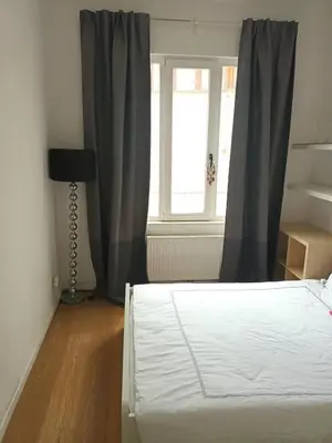 a bedroom with a bed and a window at Beautiful 2 bedroom apartment in Place Flagey bxl in Brussels