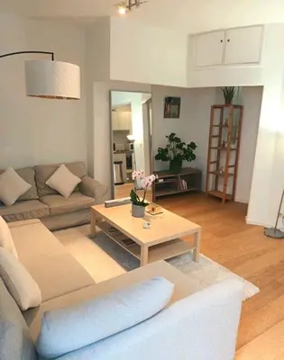 a living room with a couch and a coffee table at Beautiful 2 bedroom apartment in Place Flagey bxl in Brussels