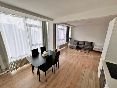 a living room with a table and chairs and a couch at LUYS Apartment in Brussels