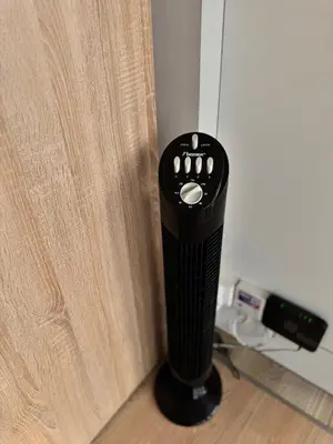 a black hair dryer next to a wooden door at LUYS Apartment in Brussels