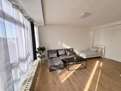 a living room with a couch and a table at LUYS Apartment in Brussels