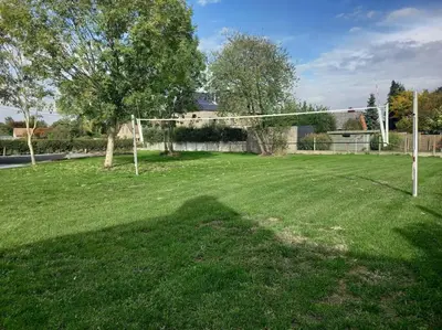 a soccer field with a net in the grass at Doornhof, rustig gelegen vakantiehuis in Haaltert
