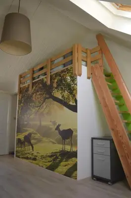 a room with a mural of deer on the wall at Doornhof, rustig gelegen vakantiehuis in Haaltert
