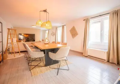 a living room with a dining room table and chairs at Calya Family Home in Brussels - 4 Bedrooms in Sint-Pieters-Leeuw