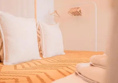 a bedroom with a bed with white pillows at Calya Family Home in Brussels - 4 Bedrooms in Sint-Pieters-Leeuw