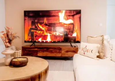 a living room with a fireplace and a couch at Calya Family Home in Brussels - 4 Bedrooms in Sint-Pieters-Leeuw