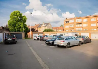 a bunch of cars parked in a parking lot at Calya Family Home in Brussels - 4 Bedrooms in Sint-Pieters-Leeuw