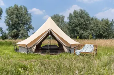 a tent in the middle of a field at Rosephine Glamping in Lievegem