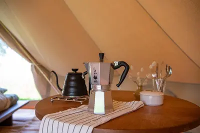 a coffee maker sitting on a wooden table at Rosephine Glamping in Lievegem