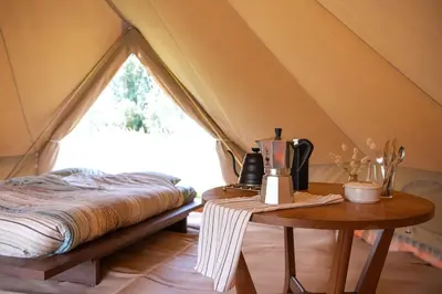 a room with a bed in a tent at Rosephine Glamping in Lievegem