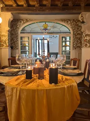 a dining room with a table with candles on it at La Petite Foret Art Deco Apartment in Brussels in Brussels