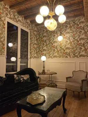 a living room with a couch and a table at La Petite Foret Art Deco Apartment in Brussels in Brussels