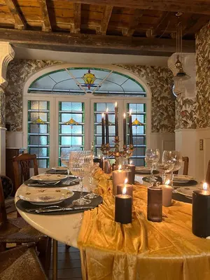 a dining room with a table with candles on it at La Petite Foret Art Deco Apartment in Brussels in Brussels