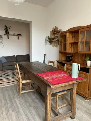 a dining room with a wooden table and chairs at Appartement cozy à Saint-Gilles in Brussels