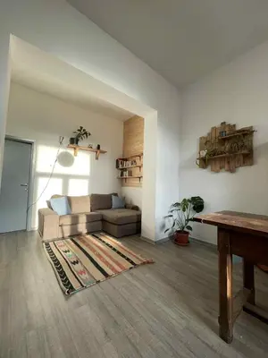 a living room with a couch and a table at Appartement cozy à Saint-Gilles in Brussels