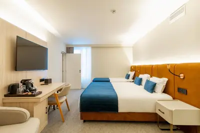 a hotel room with a bed and a desk at The Liman Hotel in Brussels