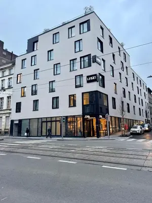 a large white building on a city street at The Liman Hotel in Brussels