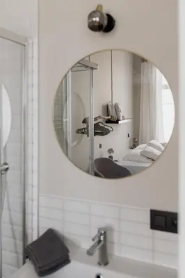 a bathroom with a mirror over a sink at Mooi licht appartement in bruisend Antwerpen! in Antwerp