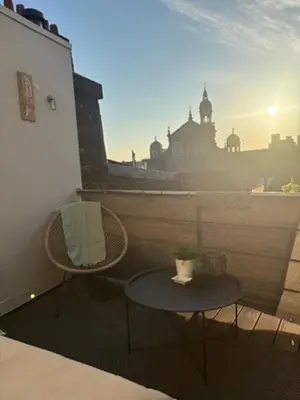 a patio with two chairs and a table on a balcony at Mooi licht appartement in bruisend Antwerpen! in Antwerp