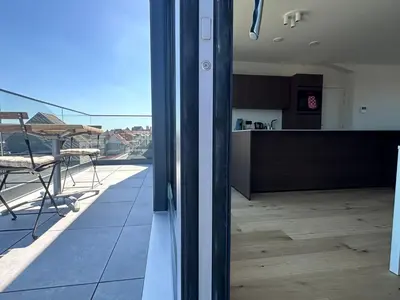 a view of a kitchen and a living room at Ghent Penthouse in Ghent