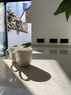 two cups sitting on a counter in a room at Jardin du Béguinage - Peaceful Luxury Home in Brussels in Brussels