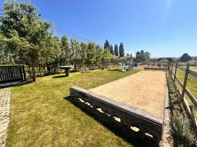 a park with a bench and a playground at Square Shaped Farmhouse from 1713 in Nieuwenhove