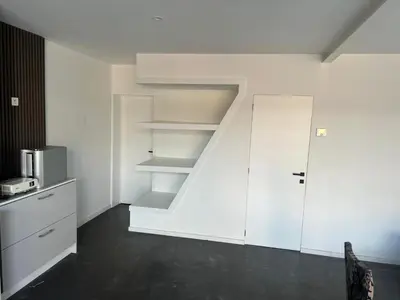 a room with white shelves and a staircase at House 5 minutes walk to Tomorrowland in Boom