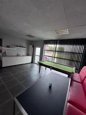 a room with a pool table and a red couch at House 5 minutes walk to Tomorrowland in Boom