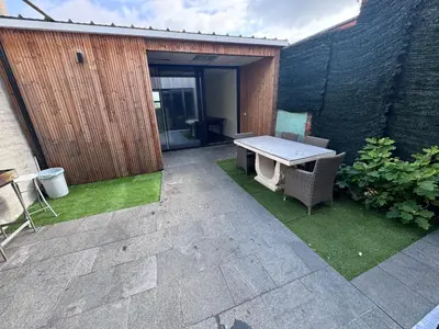 a patio with a table and a bench in a yard at House 5 minutes walk to Tomorrowland in Boom