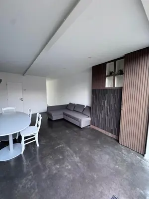 a living room with a couch and a table at House 5 minutes walk to Tomorrowland in Boom