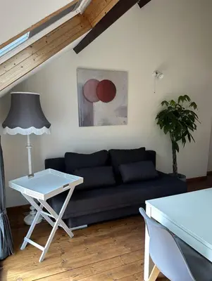 a living room with a couch and a table at CasaVerde Family House With Duplex Suite in Ghent