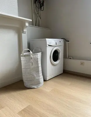 a washing machine in a laundry room with a basket at CasaVerde Family House With Duplex Suite in Ghent