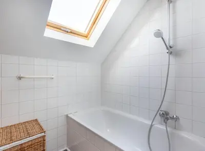 a bathroom with a bath tub and a window at Élégance Cinquantenaire in Brussels