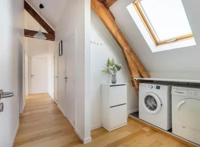 a laundry room with a washer and dryer at Élégance Cinquantenaire in Brussels