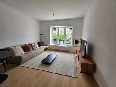 a living room with a couch and a tv at Centre de Bruxelles Merveilleux ! in Brussels