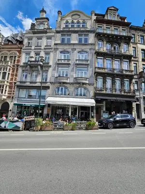 a large building on the side of a city street at Centre de Bruxelles Merveilleux ! in Brussels