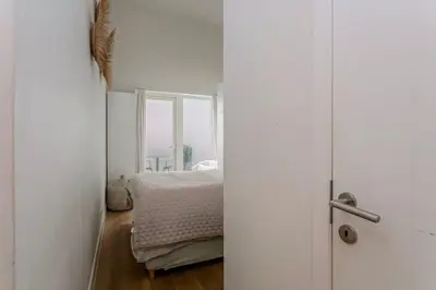 a bedroom with a bed and a window at 1-BR Centre Antwerp Haven with Patio in Antwerp
