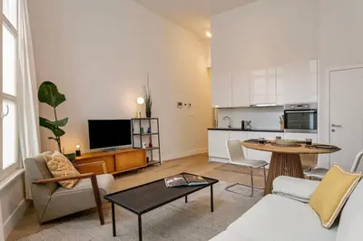 a living room with a couch and a table at 1-BR Centre Antwerp Haven with Patio in Antwerp