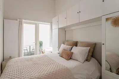 a bedroom with a large bed with a large window at 1-BR Centre Antwerp Haven with Patio in Antwerp
