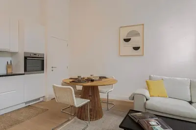 a living room with a table and a couch at 1-BR Centre Antwerp Haven with Patio in Antwerp