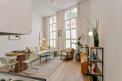 a living room with a couch and a table at 1-BR Centre Antwerp Haven with Patio in Antwerp