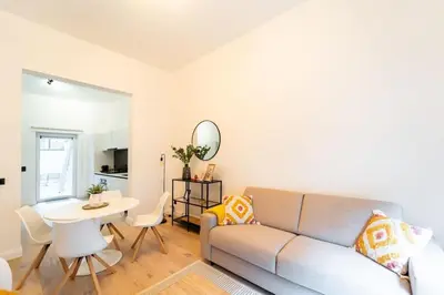 a living room with a couch and a table at Your Antwerp Adventure Sleeps 4 in Antwerp