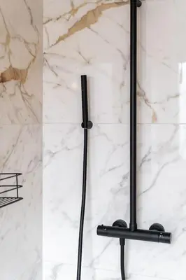 a black towel rack on a white marble wall at Your Antwerp Adventure Sleeps 4 in Antwerp