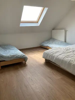 a bedroom with two beds and a skylight at Bright appartement in Zaventem
