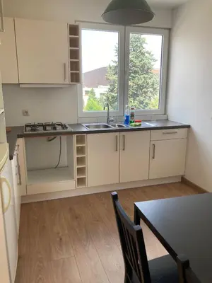 an empty kitchen with a sink and a window at Bright appartement in Zaventem