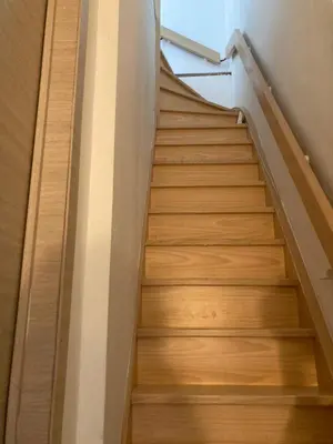 a staircase in a building with wooden floors at Bright appartement in Zaventem