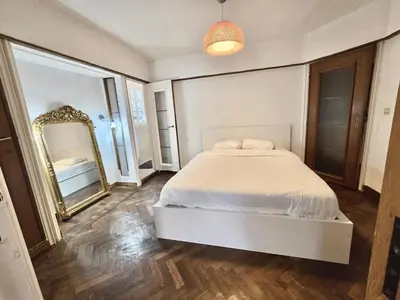 a bedroom with a large bed and a mirror at Résidence Marianne in Brussels