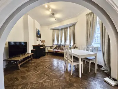 a living room with an archway with a table and chairs at Résidence Marianne in Brussels