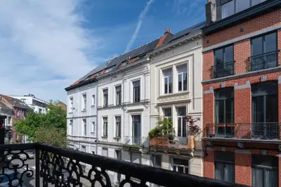 a row of white buildings on a city street at Brussels Flagey Elegant in Brussels