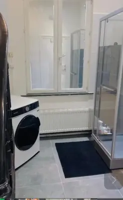 a small kitchen with a stove and a window at Quarto da Nessa próximo a Louise in Brussels